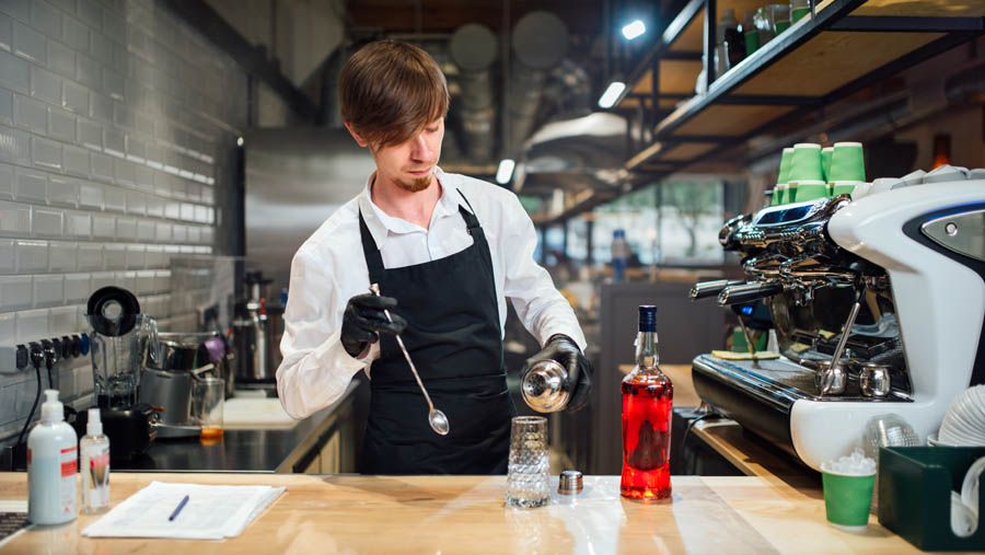 The bartender prepares a cocktail. Work in kitchen of public catering